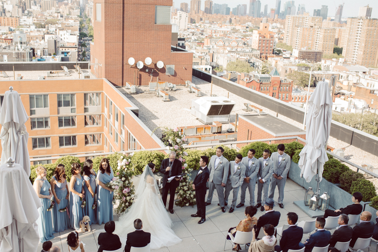 Public Hotel NYC spring rooftop wedding with Stella and Peter. NYC began to loosen COVID restrictions so events and weddings were finally allowed. Stella and Peter were able to keep their original wedding date, but unfortunately Stella's parents couldn't make it to the wedding due to COVID travel restrictions. Stella and Peter's wedding took place on 17th floor with rooftop access at the Public Hotel. Their wedding ceremony was on the rooftop, as well as their first look and some photos then we wandered around the hotel and took some epic photos at the pent house and escalator. Public Hotel NYC was so fun to photograph and I had the coolest, the most chill couple to work with. Stella and Peter's epic wedding at Public Hotel NYC photographed by Karis | Hey Karis.